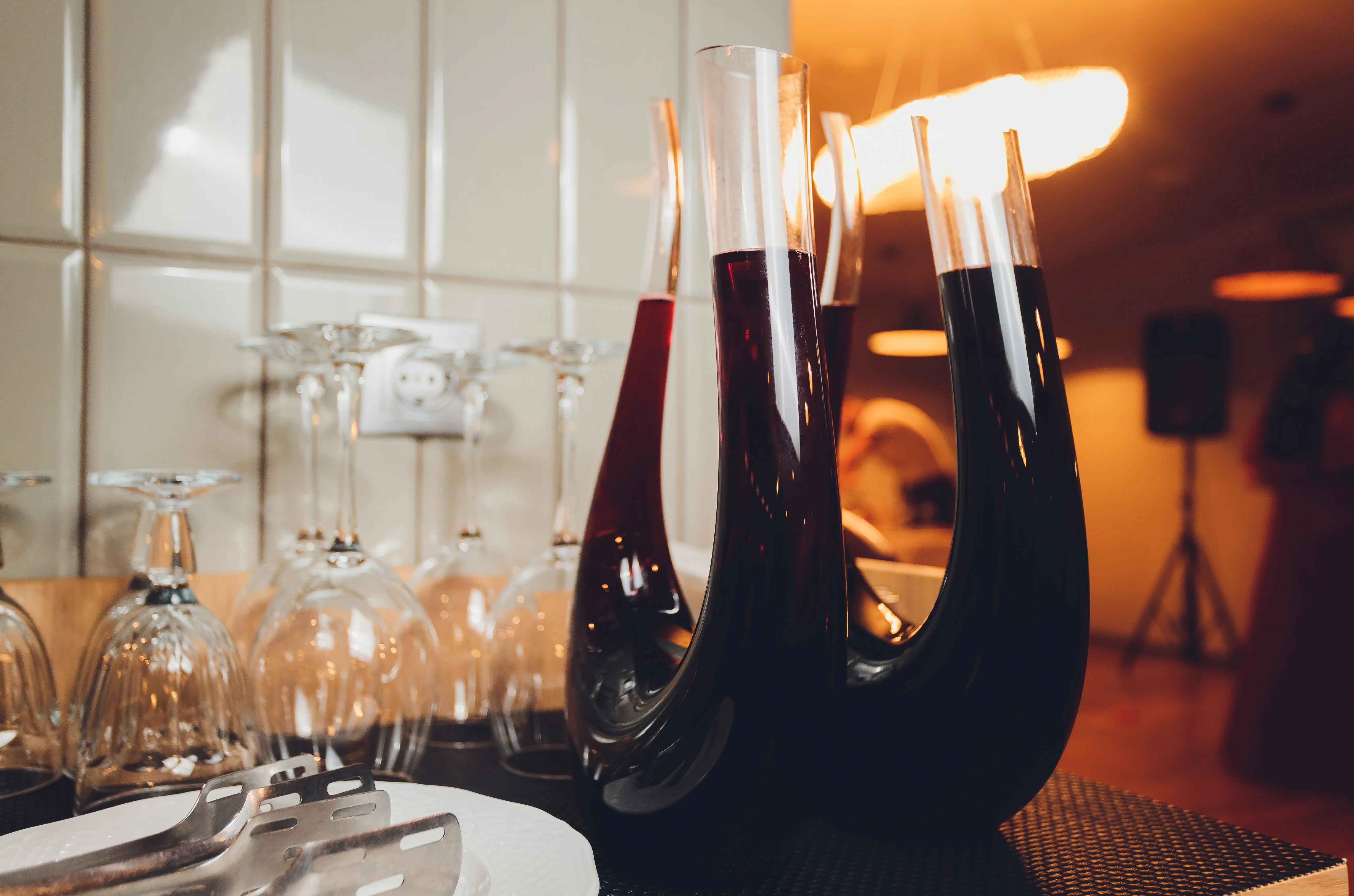 Amber wine. A splash of wine in a decanter. Traditional wine made using ancient Georgian techniques. Concept. Copy space. Close-up and vertical orientation.