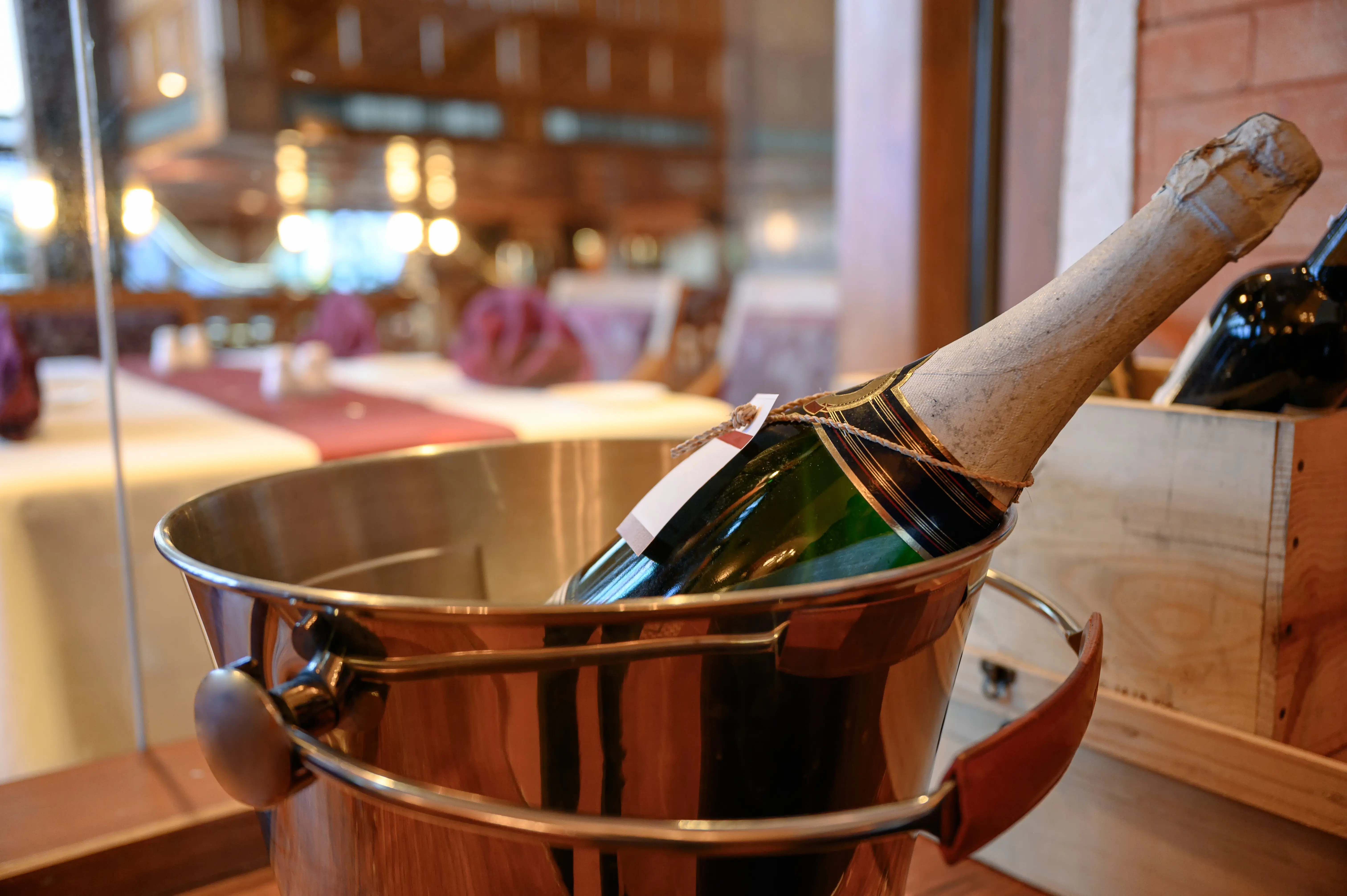 A champagne bottle immersed in a bucket.
